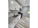 Modern kitchen featuring white cabinets, granite countertops, and stainless steel appliances at 9526 Burrwood Ct, Indianapolis, IN 46235