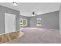Bright and spacious living room with plush carpet, neutral walls, and abundant natural light at 10187 Yosemite Ln, Indianapolis, IN 46234