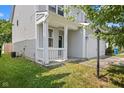 View of home's facade showing a white railed porch and entry door at 10427 Apple Creek Dr, Indianapolis, IN 46235