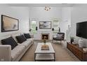 Bright living room features a fireplace, neutral furnishings, and natural light at 10427 Apple Creek Dr, Indianapolis, IN 46235