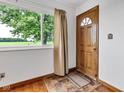 Bright entryway with a wood front door, decorative window, and a view of the outdoors at 10965 W Base Line Rd, Jamestown, IN 46147