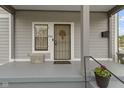 Inviting front porch featuring stylish details, including a decorative door and charming flower pots at 134 N Elder Ave, Indianapolis, IN 46222