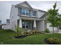 Beautiful home featuring a well-maintained lawn, lovely landscaping, and a welcoming front porch at 1439 Silver Pine Ln, Sheridan, IN 46069
