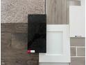 Selection of interior finish samples including flooring, granite countertop, cabinet door, and tile options at 15934 Meadow Frost Ct, Fishers, IN 46037