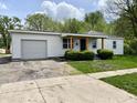 Delightful single-story home with attached garage, charming front porch, and well-kept lawn at 1649 N Arsenal Ave, Indianapolis, IN 46218