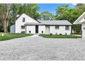 Charming two-story home with freshly painted white brick, professional landscaping, and gravel driveway at 1805 Center Valley Rd, Martinsville, IN 46151