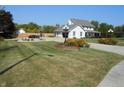 Beautifully landscaped front yard showcasing a charming two-story home with a long driveway at 2020 N Hickory Blvd, Greenfield, IN 46140