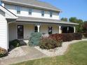 Welcoming front porch with decorative landscaping and a charming entrance to the home at 2020 N Hickory Blvd, Greenfield, IN 46140