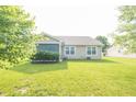 Spacious backyard featuring a well-maintained lawn and a view of the house at 2402 Foxtail Dr, Plainfield, IN 46168