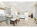 Bright open-concept kitchen with light gray cabinets, white countertops, and adjacent living area at 278 Evening Bay Ct, Pendleton, IN 46064