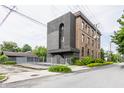 Brick building with modern addition featuring a fenced lot and residential street at 3959 Central Ave, Indianapolis, IN 46205