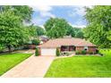 Sprawling property showcasing lush greenery, a long driveway, and a well-maintained brick home exterior at 4080 Wander Way, Greenwood, IN 46142