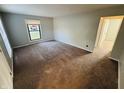 A carpeted bedroom offers a blank canvas with neutral walls, a large window, and ample natural light at 4408 Clovelly Ct, Indianapolis, IN 46254
