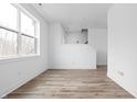 Bright living room with wood flooring and large window, offering natural light and a spacious feel at 443 Flora Pl, Carmel, IN 46290