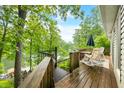 Back deck with chairs overlooking a green treeline at 460 W Hinshaw Dr, Nineveh, IN 46164