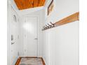 Open foyer features wood floors, entry doors, board and batten walls, and a coat rack at 460 W Hinshaw Dr, Nineveh, IN 46164
