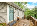 Charming front entrance with a 'Welcome to our house' sign and a wooden porch with decorative plants at 460 W Hinshaw Dr, Nineveh, IN 46164