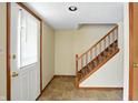 Welcoming foyer with tile flooring, wooden staircase, and neutral paint at 4749 Rocky Knob Ln, Indianapolis, IN 46254
