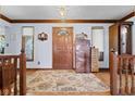 Inviting foyer with hardwood floors, a decorative rug, and natural light streaming through the windows at 476 Turnberry Ct, Avon, IN 46123