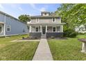 Inviting home featuring a classic covered front porch, landscaped yard, and a welcoming entrance at 4836 Winthrop Ave, Indianapolis, IN 46205