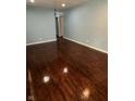 Spacious room with gleaming hardwood floors, offering a versatile living space at 4908 Elmhurst Dr, Indianapolis, IN 46226