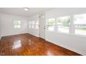 Inviting living room with beautiful hardwood floors and an abundance of natural light at 517 N Leland St, Fortville, IN 46040