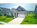 Beautifully landscaped single-Gathering home featuring an attached two-car garage and well-kept lawn at 5199 Green Valley Ln, Noblesville, IN 46062
