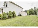 Spacious backyard featuring a storage shed, mature trees, and well-maintained lawn at 5234 Melbourne Rd, Indianapolis, IN 46228