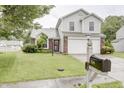 Charming home with a manicured lawn, a two-car garage, and a mailbox with the house number at 5234 Melbourne Rd, Indianapolis, IN 46228