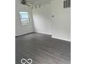 Bright living room featuring new flooring and a ceiling fan at 5312 N Kercheval Dr, Indianapolis, IN 46226