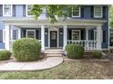 Inviting front porch with white columns, manicured bushes, and a stylish front door, creating a warm welcome at 5538 N 700 W, McCordsville, IN 46055