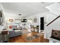 Bright and airy living room with hardwood floors, a comfortable sectional sofa, and sunroom at 5922 Broadway St, Indianapolis, IN 46220