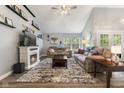 Cozy living room with a fireplace, ceiling fan, and large window with view of the outdoors at 5986 Regency Dr, Columbus, IN 47203