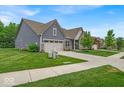 Beautifully landscaped home with an attached two car garage, and a manicured front lawn at 6536 Apperson Dr, Noblesville, IN 46060