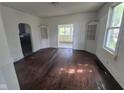 Open living room with hardwood floors, white walls, and built-in display cabinets at 711 W Centennial Ave, Muncie, IN 47303