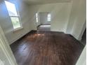 View of open living room showcasing hardwood floors, natural light, and arched doorways at 711 W Centennial Ave, Muncie, IN 47303