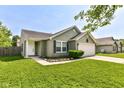 Inviting front of a cozy home features a manicured lawn and a classic design, with a two car garage at 7639 Foxglove Ln, Noblesville, IN 46062