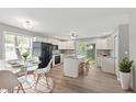 Modern kitchen featuring white cabinets, stainless steel appliances, an island, and adjacent dining area, perfect for entertaining at 7928 Vontress St, Coatesville, IN 46121