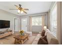 Bright living room with hardwood floors, large windows, and neutral paint tones, offering a cozy and inviting atmosphere at 7928 Vontress St, Coatesville, IN 46121