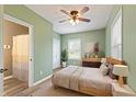 Calming main bedroom featuring a ceiling fan, natural light, and wood flooring offering a tranquil retreat at 7928 Vontress St, Coatesville, IN 46121