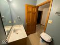 Bathroom featuring a sink with a wood framed mirror and a standard toilet at 902 St Andrews Dr, Avon, IN 46123