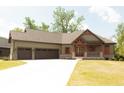 Craftsman-style home with a 3-car garage, wood accents, and inviting curb appeal at 10101 - Lot 2 N Alford Rd, Fortville, IN 46040