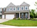 Beautiful two-story home with brick and gray siding, a well-maintained lawn, and inviting curb appeal at 10113 Gallop Ln, Fishers, IN 46040