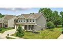 Beautiful two-story home with brick and siding exterior, attached garage, and well-maintained lawn on a corner lot at 10113 Gallop Ln, Fishers, IN 46040
