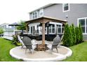 An inviting outdoor space with a covered pavilion, fire pit, and seating area perfect for gatherings at 10113 Gallop Ln, Fishers, IN 46040