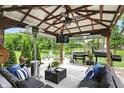 Relaxing outdoor area with comfortable seating, a grill, and a view of the serene backyard at 10113 Gallop Ln, Fishers, IN 46040