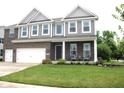 Inviting two-story home showcasing a brick facade, well-kept lawn, and a welcoming front porch at 10113 Gallop Ln, Fortville, IN 46040