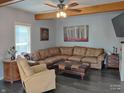 Cozy living room with a comfortable sofa, accent chair, and exposed beam at 121 N Main St, Pendleton, IN 46064