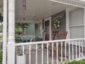 Inviting front porch with swing, rocking chairs and decorative wreath at 121 N Main St, Pendleton, IN 46064