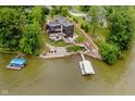 Aerial view of the property with a dock, waterfront access and mature trees at 121 Wesley Cir, Noblesville, IN 46062